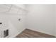 Bright laundry room featuring wood-look flooring and white walls at 210 Sharon Ln, Loganville, GA 30052