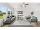 Bright living room with neutral decor, comfortable seating, and large windows with outdoor views at 210 Sharon Ln, Loganville, GA 30052