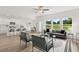 Bright, open living room with modern furnishings, kitchen, dining area, and large windows at 210 Sharon Ln, Loganville, GA 30052