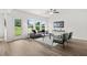 Bright living room with modern furniture, ceiling fan, and natural light from large windows at 210 Sharon Ln, Loganville, GA 30052