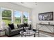Cozy living room with large windows, modern decor, and stylish furniture at 210 Sharon Ln, Loganville, GA 30052