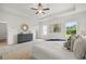 Stylishly appointed main bedroom featuring a tray ceiling, and natural light from large windows at 210 Sharon Ln, Loganville, GA 30052