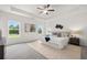 Spacious main bedroom with tray ceiling, plush carpet, and natural light from large windows at 210 Sharon Ln, Loganville, GA 30052