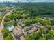 An aerial view showing a neighborhood with a pool, trees, and Atlanta skyline at 262 Southerland Ne Ter, Atlanta, GA 30307
