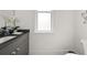 Bright bathroom with frosted window, vanity with black countertop, and a white toilet at 262 Southerland Ne Ter, Atlanta, GA 30307