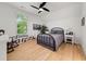 Cozy bedroom with hardwood floors, large window, and a wrought iron bed frame and ceiling fan at 262 Southerland Ne Ter, Atlanta, GA 30307