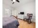 Cozy bedroom with hardwood floors features a rocking chair and ensuite bathroom at 262 Southerland Ne Ter, Atlanta, GA 30307