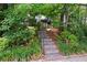 Exterior steps lead to a home with mature landscaping at 262 Southerland Ne Ter, Atlanta, GA 30307