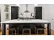 Modern kitchen with a large island, sleek black cabinets, white countertops, and bar stool seating at 262 Southerland Ne Ter, Atlanta, GA 30307