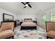 Serene main bedroom features vaulted ceilings, a comfortable bed, and stylish decor at 262 Southerland Ne Ter, Atlanta, GA 30307