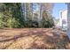 Spacious backyard featuring mature trees, a patio, and plenty of room for outdoor activities at 538 Shadowmoore Dr, Riverdale, GA 30274