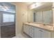 The bathroom has double sinks with generous counterspace, vanity, and tile flooring at 538 Shadowmoore Dr, Riverdale, GA 30274