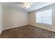 Neutral bedroom featuring a window and carpeted floors at 538 Shadowmoore Dr, Riverdale, GA 30274