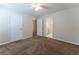 This bedroom features neutral paint, carpet, ceiling fan, and access to the bathroom at 538 Shadowmoore Dr, Riverdale, GA 30274