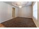 Carpeted dining room featuring an elegant chandelier and a large window for natural light at 538 Shadowmoore Dr, Riverdale, GA 30274