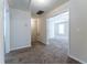 Neutral hallway that leads to a bedroom with a ceiling fan at 538 Shadowmoore Dr, Riverdale, GA 30274