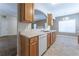 Kitchen with wooden cabinets and sink looking to a dining area and living area at 538 Shadowmoore Dr, Riverdale, GA 30274