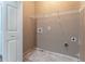 There is a storage shelf above the hookups in this dedicated laundry room with tile flooring at 538 Shadowmoore Dr, Riverdale, GA 30274
