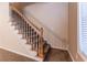 Carpeted staircase with wood railing and white risers at 538 Shadowmoore Dr, Riverdale, GA 30274