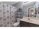 Bright bathroom featuring a sink, toilet, and a shower with a modern patterned curtain at 575 Chapel Walk Ln, Lawrenceville, GA 30045