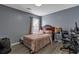 Cozy bedroom featuring neutral decor, a comfortable bed, and a well-lit workspace at 575 Chapel Walk Ln, Lawrenceville, GA 30045