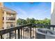 Balcony view featuring a nearby parking lot and lush green trees under a bright blue sky at 795 Hammond Dr # 505, Atlanta, GA 30328
