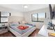 A naturally lit bedroom with wood floors, large windows, and a comfortable bed at 795 Hammond Dr # 505, Atlanta, GA 30328