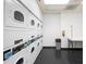 A clean laundry room with stacked washer and dryers at 795 Hammond Dr # 505, Atlanta, GA 30328