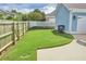 View of the fenced backyard with lush green lawn and access to a concrete patio at 230 Ryan Ln, Covington, GA 30014