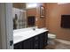 Double sink bathroom with vanity and wood-look flooring, with unique donkey-themed decor at 230 Ryan Ln, Covington, GA 30014