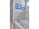 Bathroom featuring tiled walls, a shower, and a soaking tub, providing a luxurious spa-like experience at 230 Ryan Ln, Covington, GA 30014
