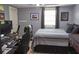 Nicely decorated bedroom with a workspace, ceiling fan, and good lighting from the window at 230 Ryan Ln, Covington, GA 30014