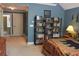 Bedroom displaying bookshelves and a comfortable bed for a cozy and functional living space at 230 Ryan Ln, Covington, GA 30014
