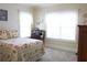 Inviting bedroom with floral bedding, a vintage desk, and lots of natural light at 230 Ryan Ln, Covington, GA 30014