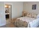 Cozy bedroom with floral bedding, bedside table, and an en-suite bathroom at 230 Ryan Ln, Covington, GA 30014