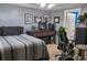 Well-lit bedroom with a ceiling fan, black and white pictures, and a comfortable work space at 230 Ryan Ln, Covington, GA 30014
