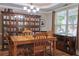 Elegant dining room featuring wooden furniture, a large hutch, and ample natural light at 230 Ryan Ln, Covington, GA 30014