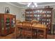 Dining room featuring elegant wooden furniture, shelving, and hardwood floors at 230 Ryan Ln, Covington, GA 30014