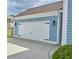Attached garage with carriage doors and a paved driveway at 230 Ryan Ln, Covington, GA 30014