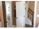Hallway view showing the stairs and an open door to a bedroom with natural wood dresser at 230 Ryan Ln, Covington, GA 30014