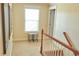Upstairs hallway with a window seat and view down the staircase at 230 Ryan Ln, Covington, GA 30014