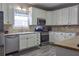 Charming kitchen with stainless steel appliances, white cabinets, and a stylish backsplash at 230 Ryan Ln, Covington, GA 30014