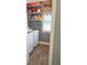 Functional laundry room with washer, dryer, storage shelves, and a bright window at 230 Ryan Ln, Covington, GA 30014