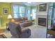 Cozy living room with a fireplace, offering a relaxing atmosphere with natural light at 230 Ryan Ln, Covington, GA 30014