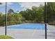 Outdoor tennis court enclosed by a fence and mature trees at 230 Ryan Ln, Covington, GA 30014