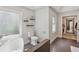 Bright bathroom featuring modern fixtures, a standalone tub, and an open doorway to an additional bathroom area at 2356 Defoors Ferry Nw Rd, Atlanta, GA 30318