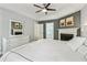 A spacious bedroom with a fireplace, tray ceiling with fan, offering comfortable living space at 2356 Defoors Ferry Nw Rd, Atlanta, GA 30318