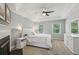 A serene bedroom featuring a fireplace, carpeted floor, and a tray ceiling with fan for relaxation at 2356 Defoors Ferry Nw Rd, Atlanta, GA 30318