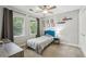Bright bedroom with a ceiling fan, plush carpet, window, closet, and minimal furniture at 2356 Defoors Ferry Nw Rd, Atlanta, GA 30318