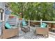 Inviting deck with wicker furniture, blue accents, and a stylish striped rug, perfect for outdoor relaxation and entertainment at 2356 Defoors Ferry Nw Rd, Atlanta, GA 30318